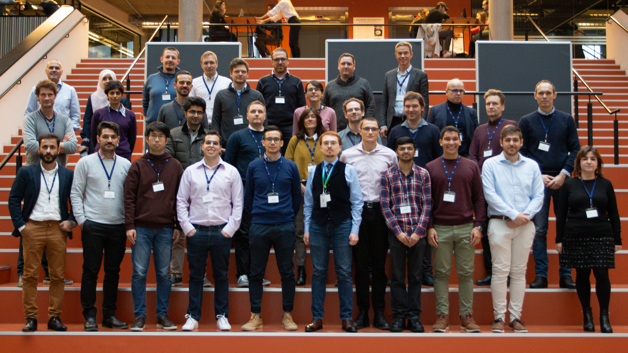 A big group of people standing and posing in rows